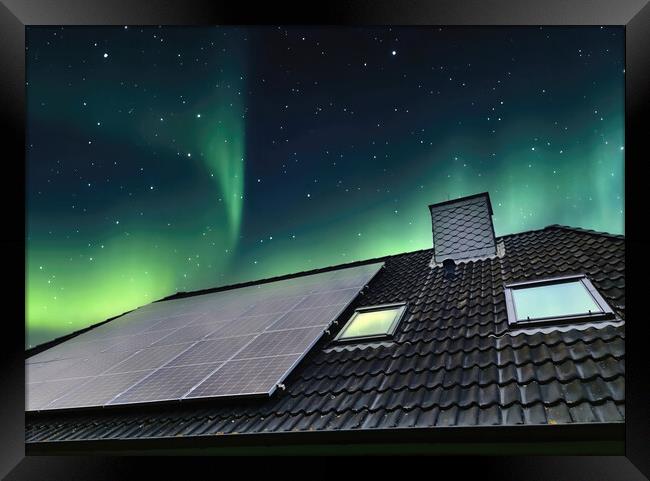 Solar panels producing clean energy on a roof of a residential h Framed Print by Michael Piepgras
