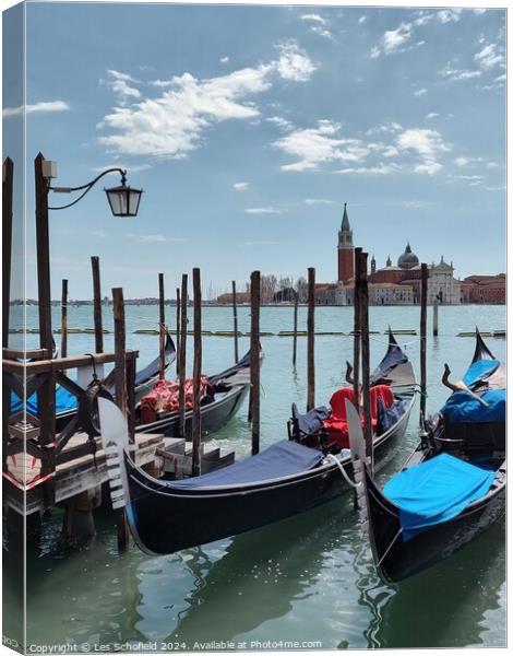 Gondolas on the Venice canal  Canvas Print by Les Schofield