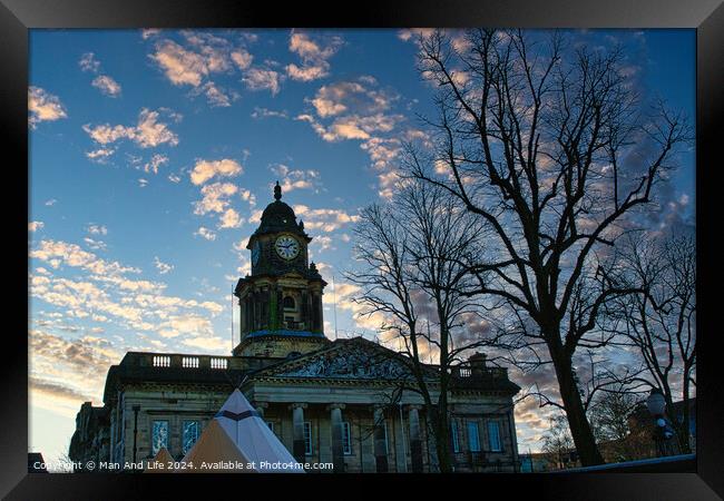 Historic building with clock tower at dusk, silhouetted trees in foreground, pink clouds in blue sky in Lancaster. Framed Print by Man And Life