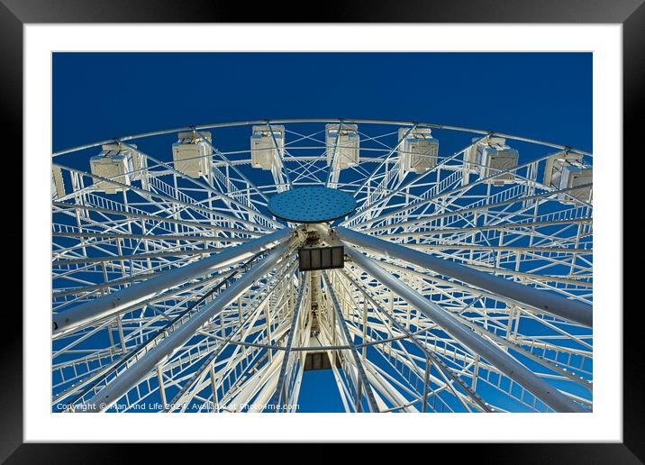 Ferris wheel against a clear blue sky, symmetrical view from below in Lancaster. Framed Mounted Print by Man And Life