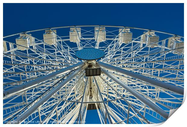 Ferris wheel against a clear blue sky, symmetrical view from below in Lancaster. Print by Man And Life
