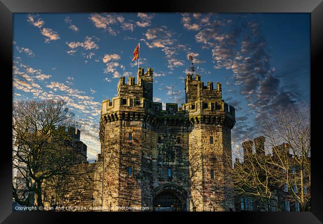 Historic stone castle with towers against a blue sky with scattered clouds at sunset in Lancaster. Framed Print by Man And Life
