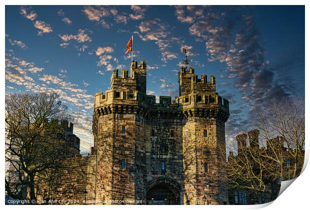 Historic stone castle with towers against a blue sky with scattered clouds at sunset in Lancaster. Print by Man And Life