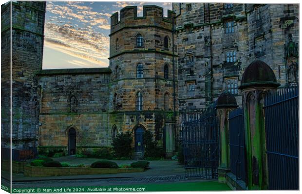 Historic stone castle at dusk with dramatic sky and greenery, suitable for travel and history themes in Lancaster. Canvas Print by Man And Life