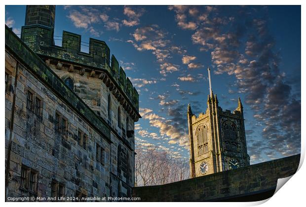 Historic stone buildings with towers against a dramatic sky at dusk in Lancaster. Print by Man And Life
