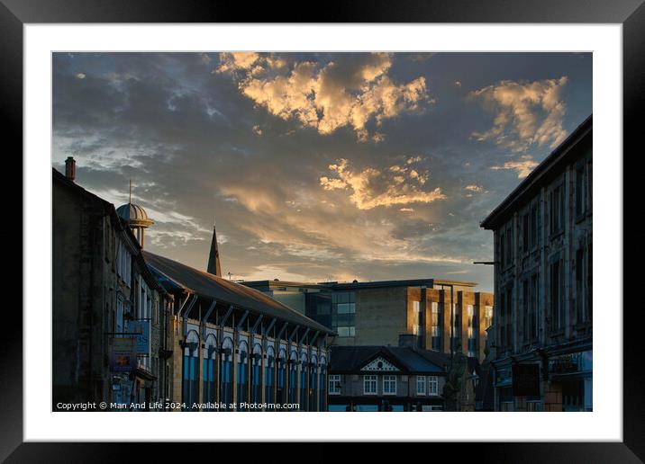 Dramatic sunset over a quaint town street with historic buildings and a vibrant sky with golden clouds in Lancaster. Framed Mounted Print by Man And Life