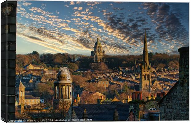 Historic cityscape at sunset with dramatic clouds, showcasing architectural landmarks and a warm golden light bathing the buildings in Lancaster. Canvas Print by Man And Life