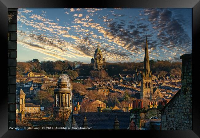 Historic cityscape at sunset with dramatic clouds, showcasing architectural landmarks and a warm golden light bathing the buildings in Lancaster. Framed Print by Man And Life