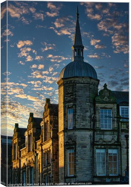 Historic stone building with a spire against a dramatic sky with golden sunset clouds in Lancaster. Canvas Print by Man And Life