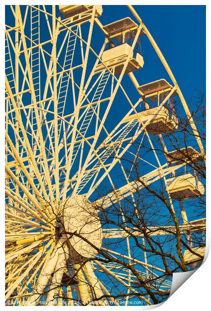 Ferris wheel against a clear blue sky with sunlight casting shadows, conveying a sense of leisure and entertainment in Lancaster. Print by Man And Life
