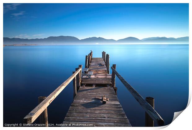 Wooden pier at sunrise. Lake Massaciuccoli, Tuscany, Italy Print by Stefano Orazzini