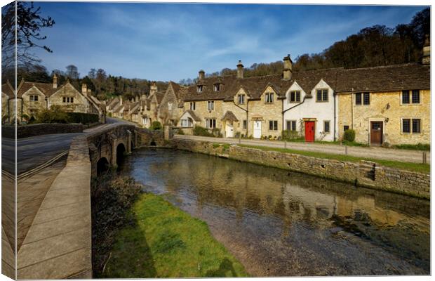 The bridge over the river in the picturesque village of Castle Combe in the Cotswolds Wiltshire UK Canvas Print by John Gilham