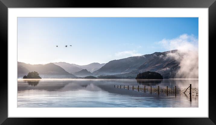 Derwent Water in Winter with geese flying over head Framed Mounted Print by Julian Carnell