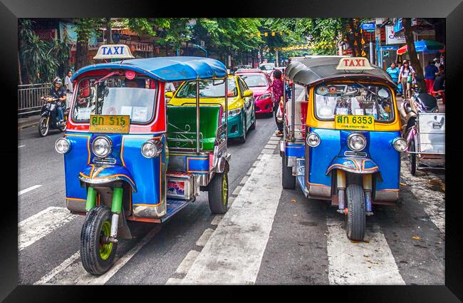 Tuk tuks on a street in the city. Framed Print by Kevin Hellon