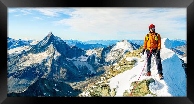 Alpine climber on the summit of Dent Blanche Framed Print by Julian Carnell