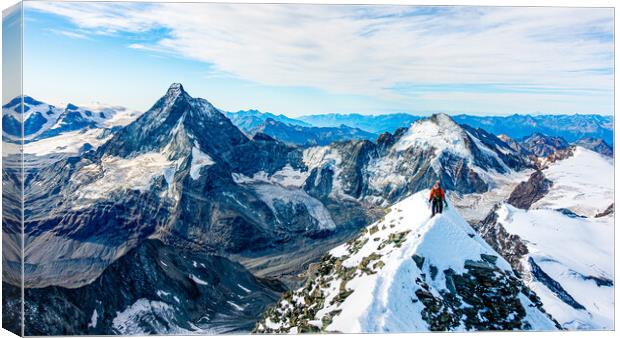 Alpinist on Dent Blanche with Matterhorn in the background Canvas Print by Julian Carnell