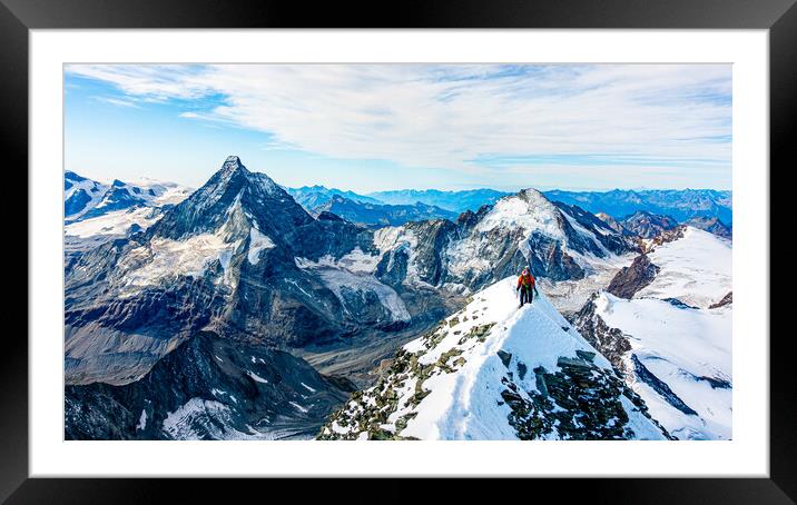 Alpinist on Dent Blanche with Matterhorn in the background Framed Mounted Print by Julian Carnell