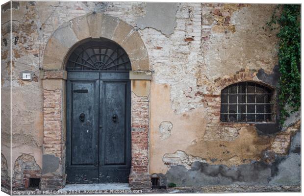 Stately aged door in Tuscany Canvas Print by Paul Edney