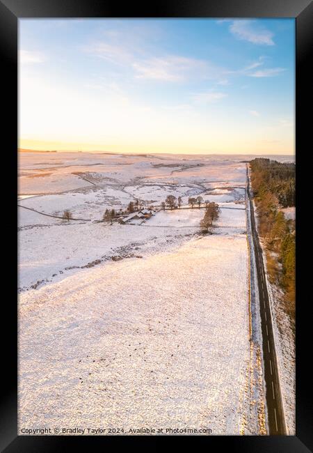 Long Snowy Road, Northumberland Framed Print by Bradley Taylor