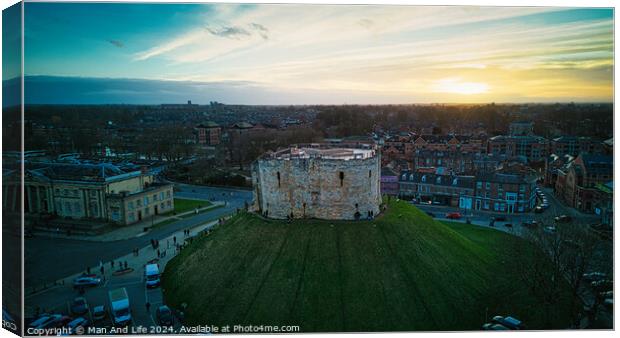 Aerial view of a historic castle at sunset with surrounding cityscape and dramatic sky in York, North Yorkshire Canvas Print by Man And Life