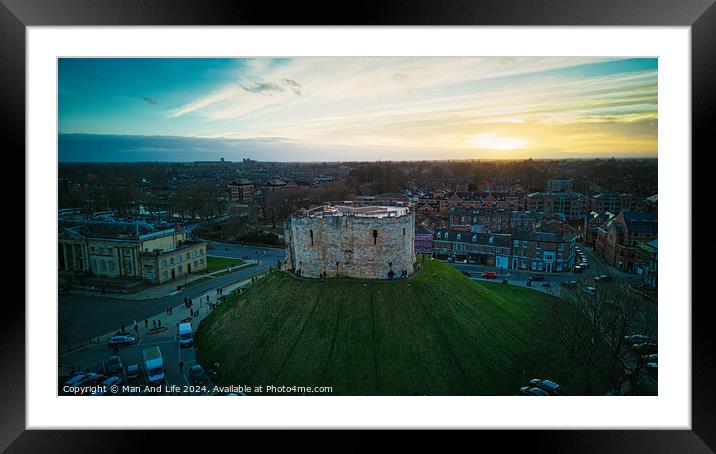 Aerial view of a historic castle at sunset with surrounding cityscape and dramatic sky in York, North Yorkshire Framed Mounted Print by Man And Life