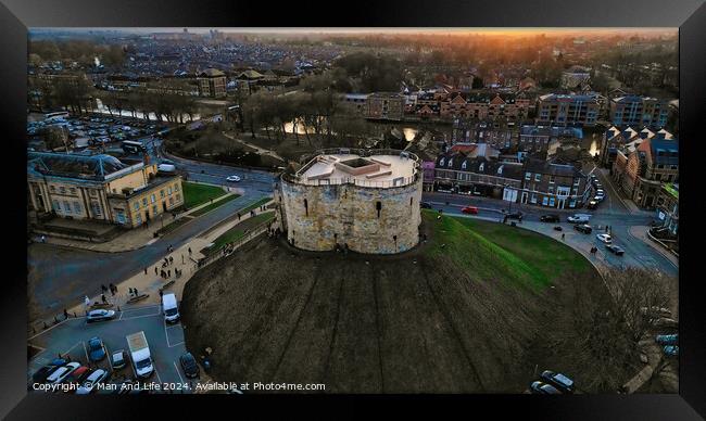 Aerial view of a historic circular stone fortress at dusk, with surrounding urban landscape and sunset sky in York, North Yorkshire Framed Print by Man And Life