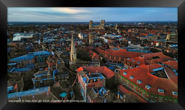 Aerial view of a historic city at dusk with prominent cathedral and urban landscape in York, North Yorkshire Framed Print by Man And Life