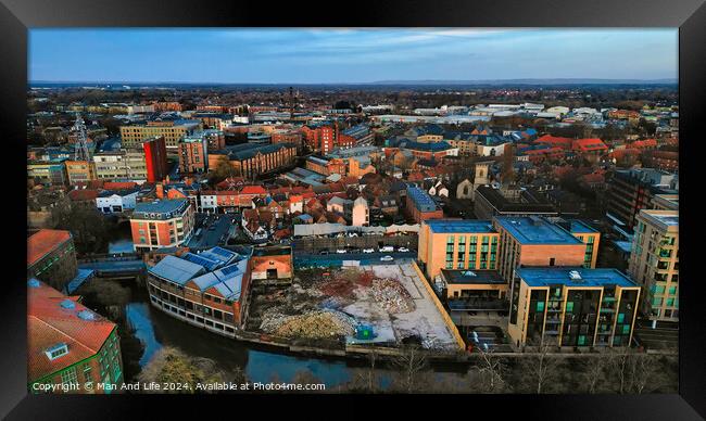 Aerial view of a modern cityscape during sunset with buildings and a river in York, North Yorkshire Framed Print by Man And Life