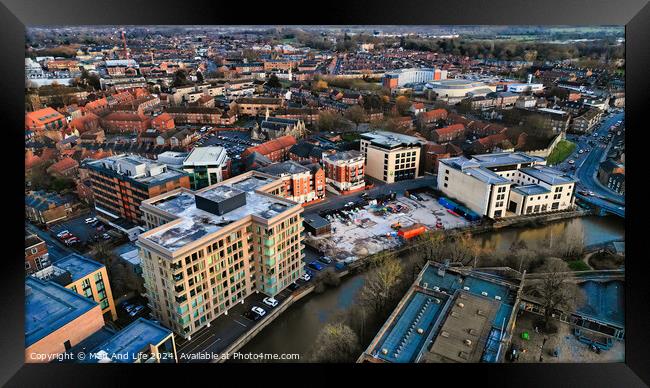Aerial view of a modern urban cityscape at dusk with buildings and roads in York, North Yorkshire Framed Print by Man And Life