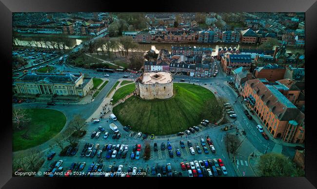 Aerial view of a historic building with a circular shape surrounded by a green lawn, parking area, and cityscape during twilight in York, North Yorkshire Framed Print by Man And Life