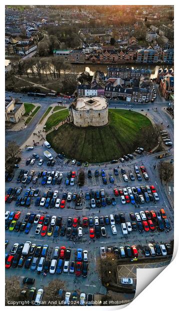 Aerial view of a circular building surrounded by a parking lot with cars during twilight in York, North Yorkshire Print by Man And Life