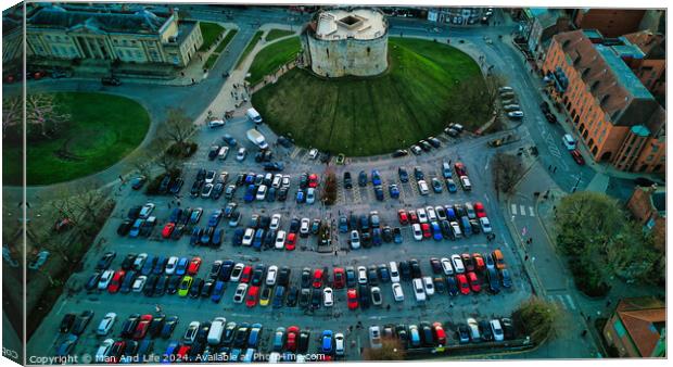 Aerial view of a circular building surrounded by a parking lot with colorful cars, showcasing urban planning and architecture in York, North Yorkshire Canvas Print by Man And Life