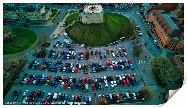 Aerial view of a circular building surrounded by a parking lot with colorful cars, showcasing urban planning and architecture in York, North Yorkshire Print by Man And Life