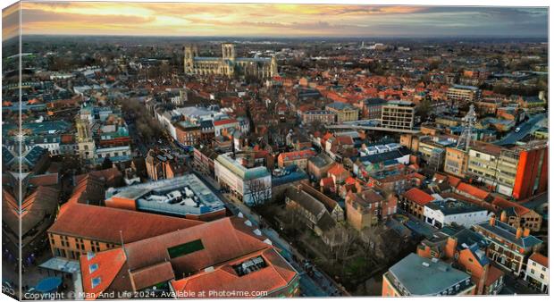Aerial view of a European city at sunset with warm lighting, showcasing historic buildings and urban landscape in York, North Yorkshire Canvas Print by Man And Life