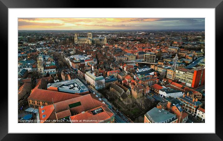 Aerial view of a European city at sunset with warm lighting, showcasing historic buildings and urban landscape in York, North Yorkshire Framed Mounted Print by Man And Life