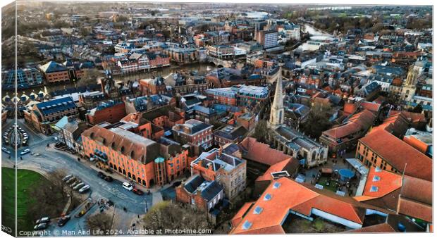 Aerial view of a historic town at dusk with warm lighting, showcasing the urban architecture and streets in York, North Yorkshire Canvas Print by Man And Life