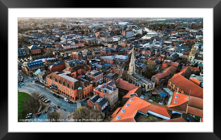 Aerial view of a historic town at dusk with warm lighting, showcasing the urban architecture and streets in York, North Yorkshire Framed Mounted Print by Man And Life