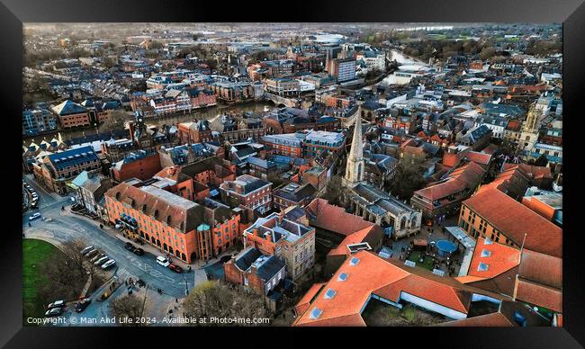 Aerial view of a historic town at dusk with warm lighting, showcasing the urban architecture and streets in York, North Yorkshire Framed Print by Man And Life