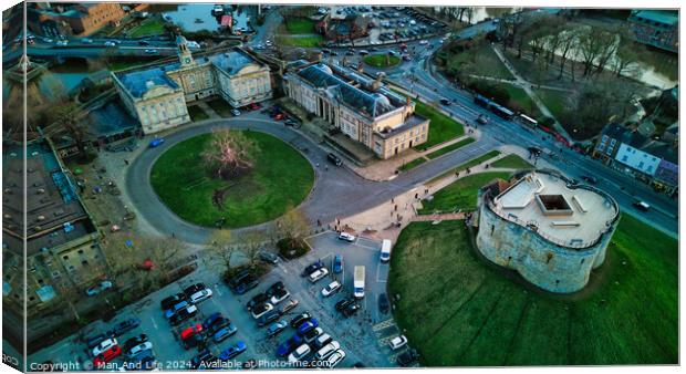 Aerial view of a historic cityscape with a roundabout, ancient buildings, and a fortress at dusk in York, North Yorkshire Canvas Print by Man And Life