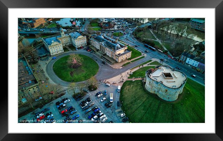Aerial view of a historic cityscape with a roundabout, ancient buildings, and a fortress at dusk in York, North Yorkshire Framed Mounted Print by Man And Life