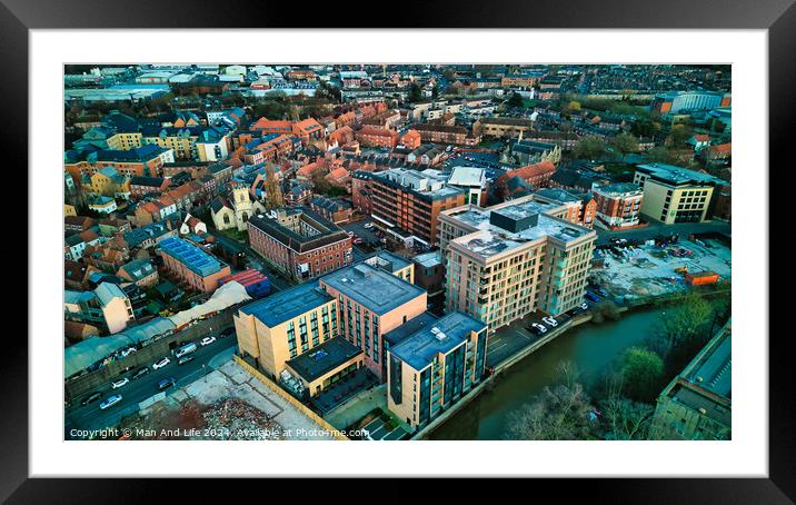 Aerial view of a vibrant urban landscape at dusk with buildings and a river in York, North Yorkshire Framed Mounted Print by Man And Life