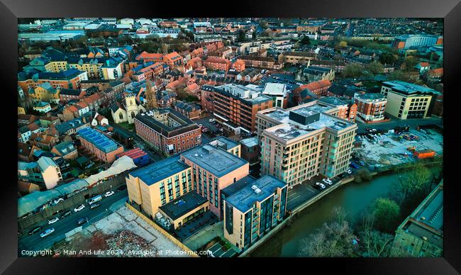 Aerial view of a vibrant urban landscape at dusk with buildings and a river in York, North Yorkshire Framed Print by Man And Life