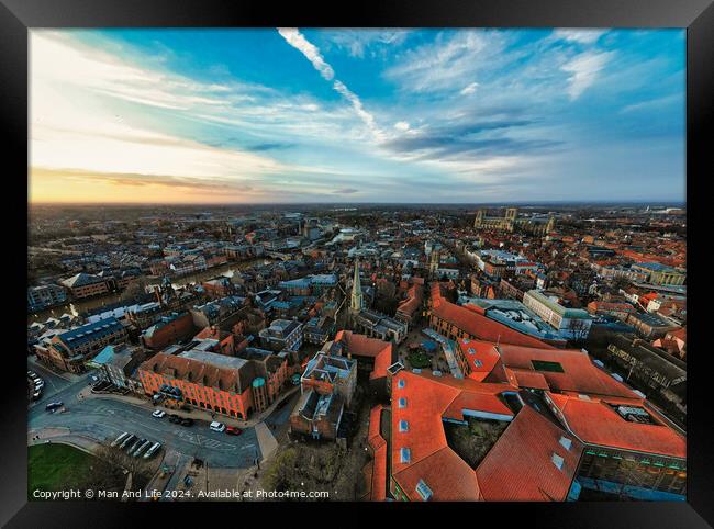 Aerial view of a European city at dusk with historic buildings and a dramatic sky in York, North Yorkshire Framed Print by Man And Life