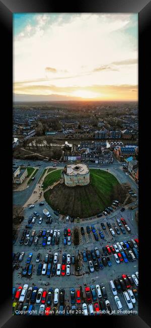 Aerial view of a parking lot and building at sunset with dramatic sky in York, North Yorkshire Framed Print by Man And Life