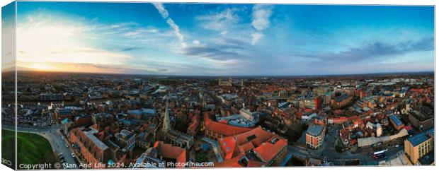 Panoramic aerial view of a cityscape at dusk with historic buildings and a dramatic sky in York, North Yorkshire Canvas Print by Man And Life