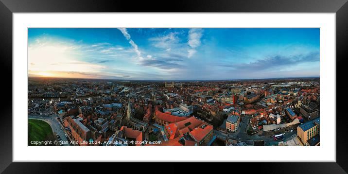 Panoramic aerial view of a cityscape at dusk with historic buildings and a dramatic sky in York, North Yorkshire Framed Mounted Print by Man And Life