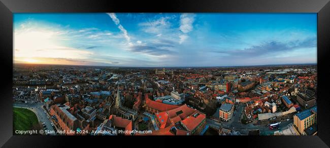 Panoramic aerial view of a cityscape at dusk with historic buildings and a dramatic sky in York, North Yorkshire Framed Print by Man And Life