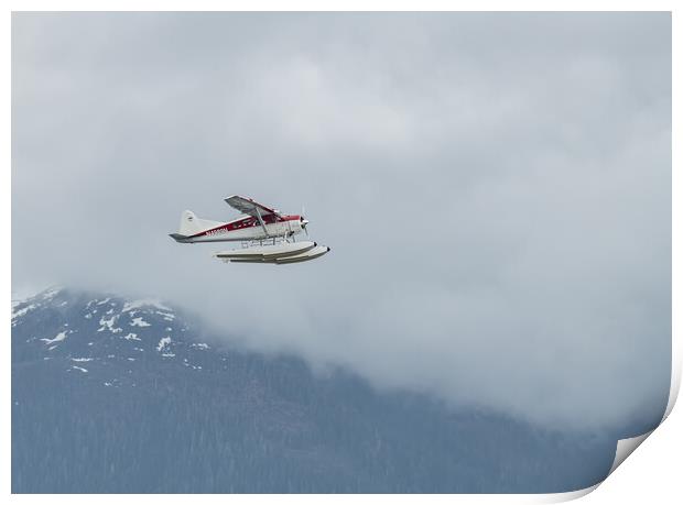 DeHavilland DHC-2 Float Plane Flying low past cloud covered mountains Alaska, USA Print by Dave Collins