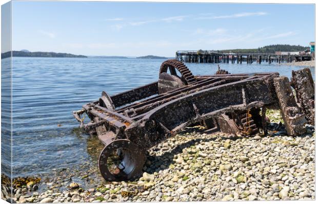 Abandoned Machinery  on the beach of Alert Bay with an old disused pier behind behind, British Columbia, Canada Canvas Print by Dave Collins