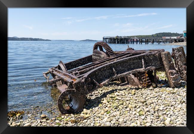 Abandoned Machinery  on the beach of Alert Bay with an old disused pier behind behind, British Columbia, Canada Framed Print by Dave Collins